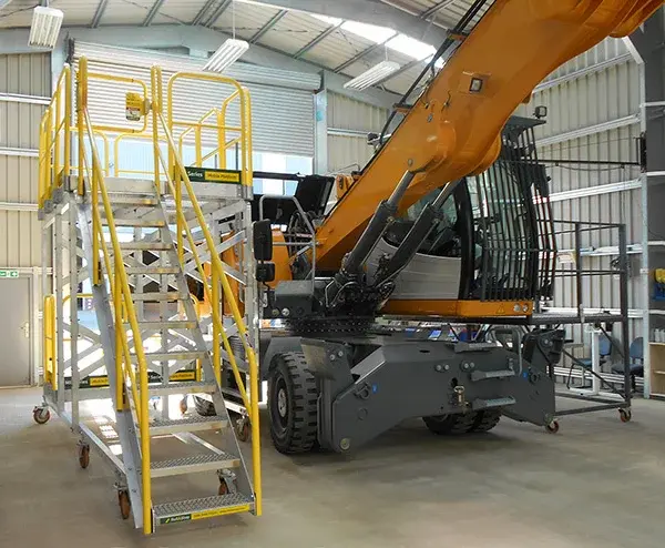 custom rolling work platform for maintenance and repair tasks shown in heavy equipment factory